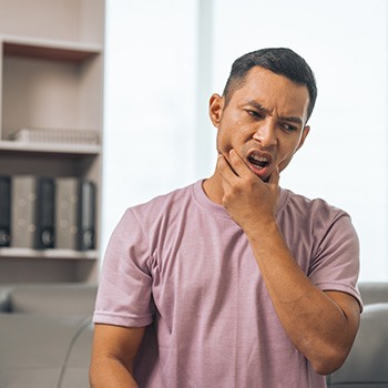 A middle-aged man suffering a dental emergency