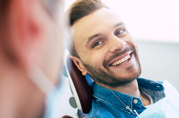 Man smiling at dentist in treatment chair