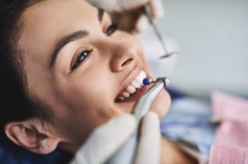 Woman having teeth polished at routine dental appointment